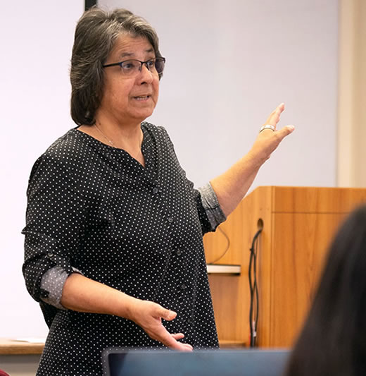 Female professor in front of class