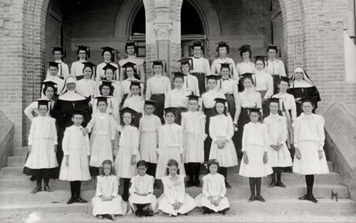 Group of children on the steps on main building