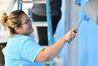 student volunteer painting