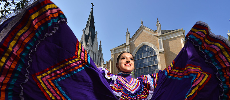 Folklorico dancer outside of chapel