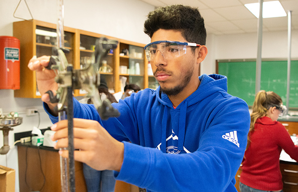 Male holding vial in lab