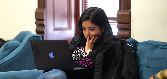 Female student lookin at laptop in study area
