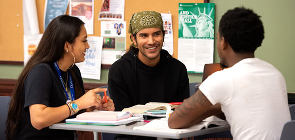 Students talking at table in cafeteria