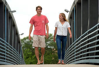 students walking on bridge