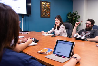 group-of-students-talking-at-conference-table