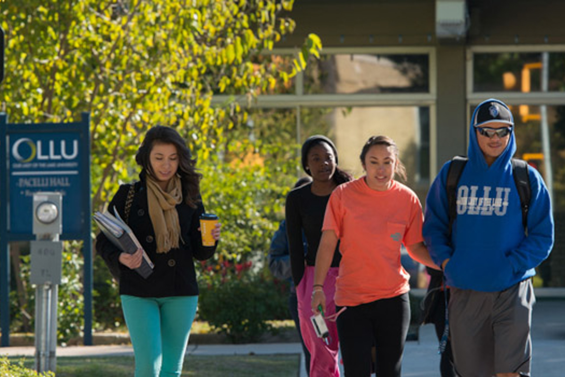 balancing-school Students walking across OLLU’s campus in San Antonio, representing the balance of work, school, and college life.