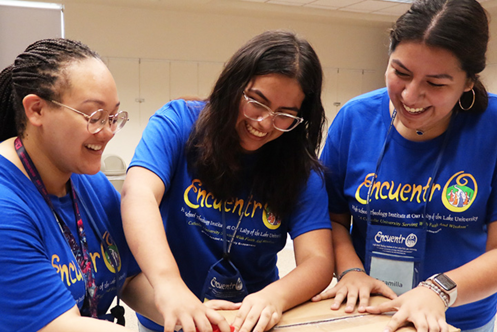 first_gen_support_lg Students at OLLU smiling and collaborating during a campus event, representing the strong support system available for first gen college students.