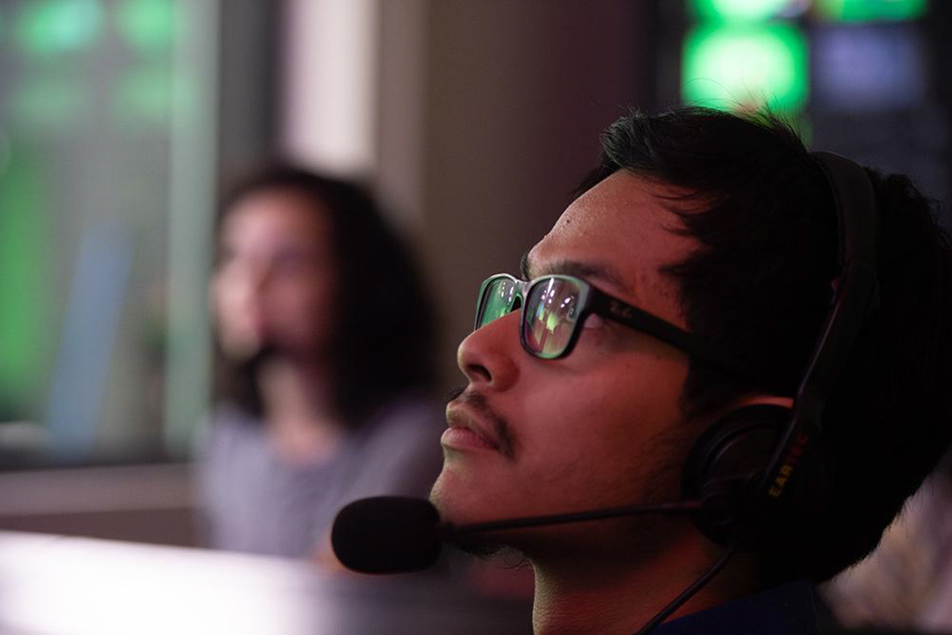 Student in headset monitoring screens in a cybersecurity lab, preparing for Texas cybersecurity careers.