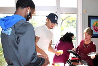 President Melby helping students as they serve food