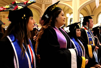Students participating in graduation ceremony in chapel