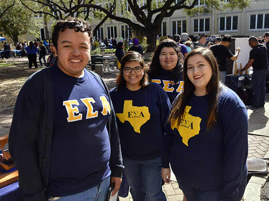 Student organization member standing outside smiling