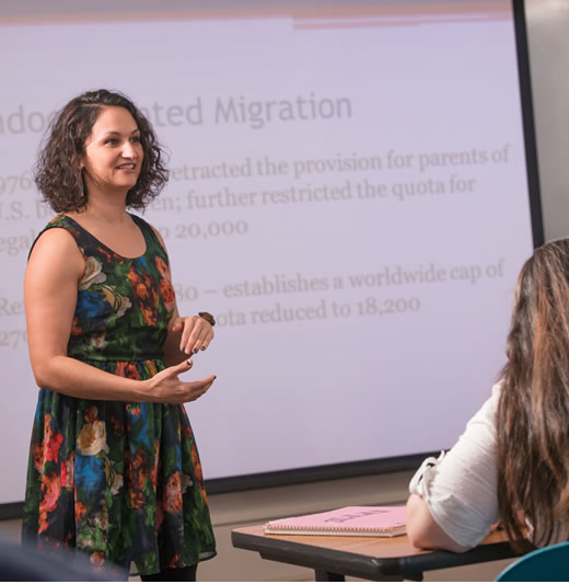 Female professor lecturing in front of class