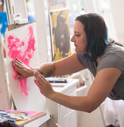 Professor creating a painting with her hands