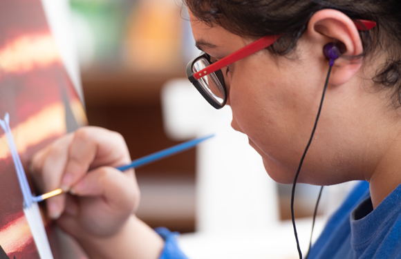 Female art student working on painting