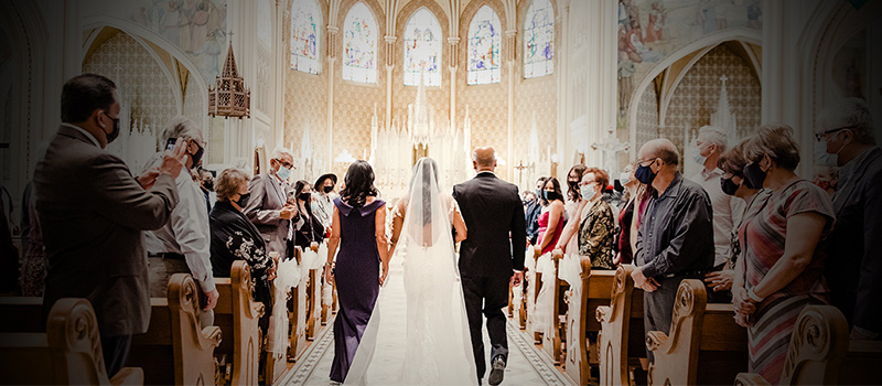 Bride walking down aisle with parents