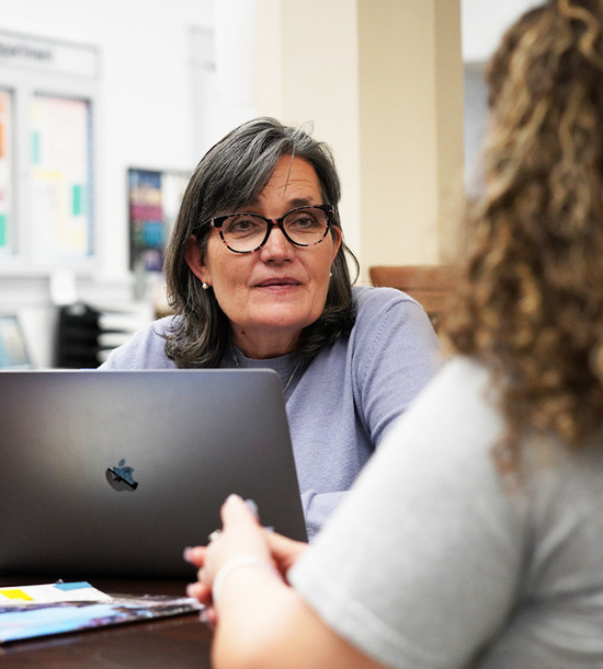 Professor sitting talking to student