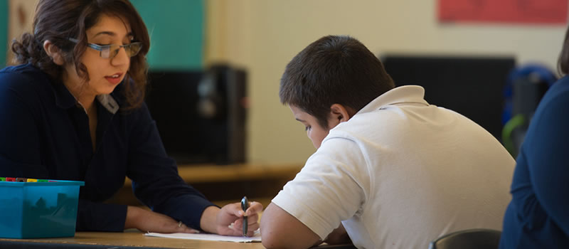 Student helping child with classwork