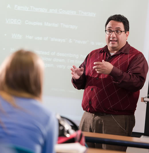 Professor lecturing in the front of the classroom