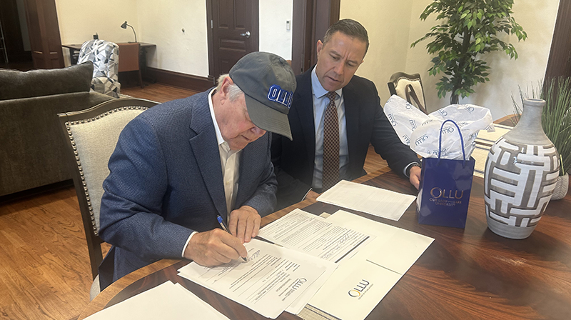 Dick Wade signs gift agreement