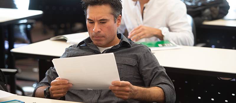 Student in class holding paper