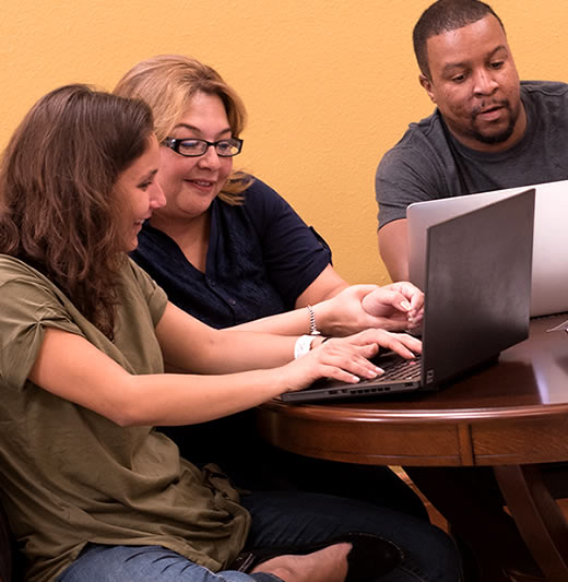 Students looking at laptop together