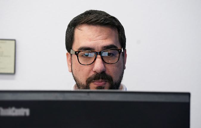 Male in front of computer screen