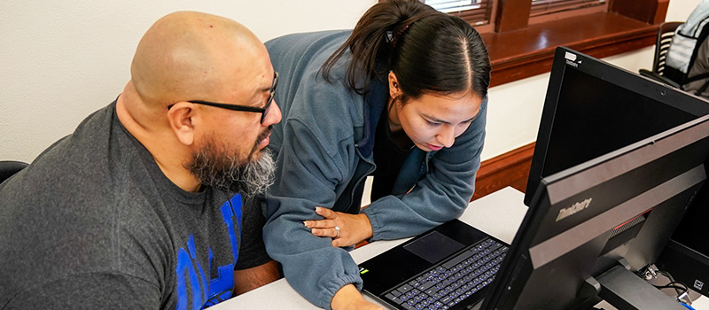 Two students using computer together