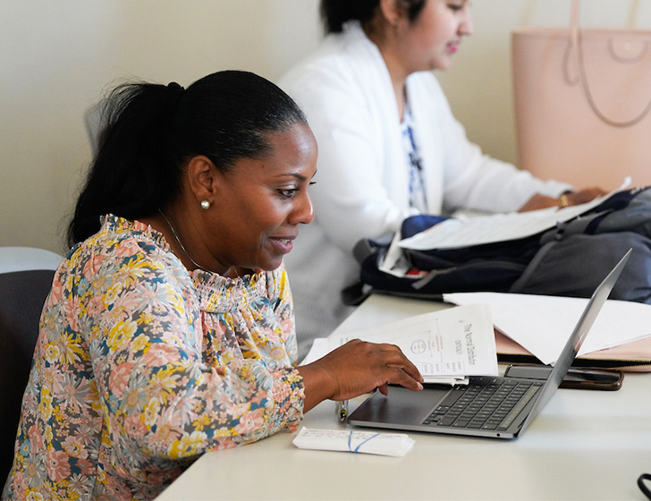 Two female students on laptops