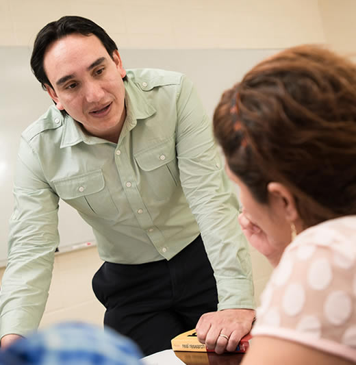 Professor talking with student in class