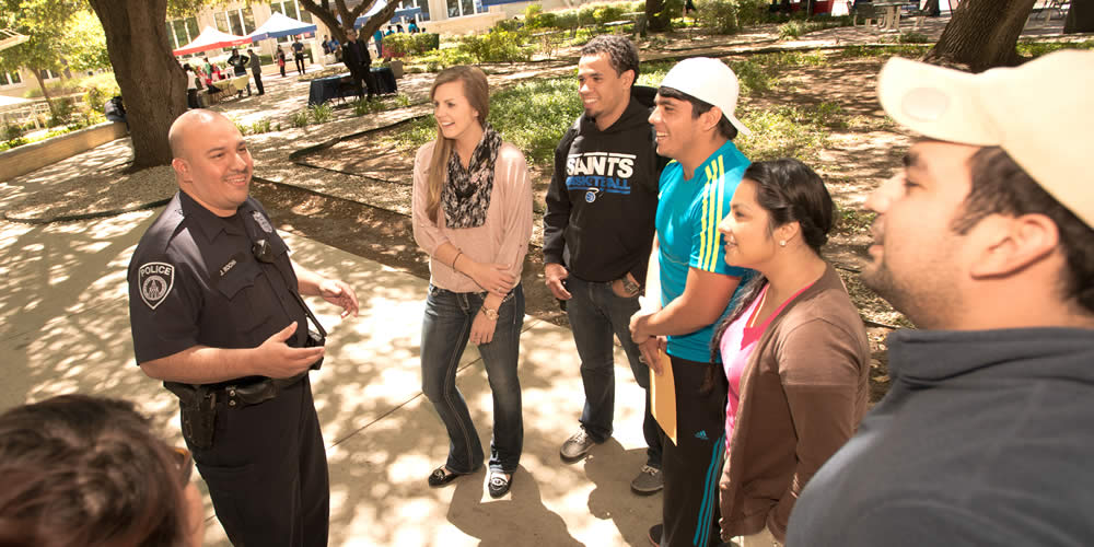 Campus officer talking with students