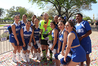 Cheer team posing with runner