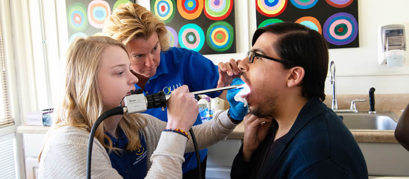 Female student and female professor examining client