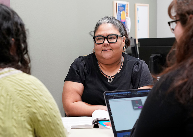 Professor talking with two students